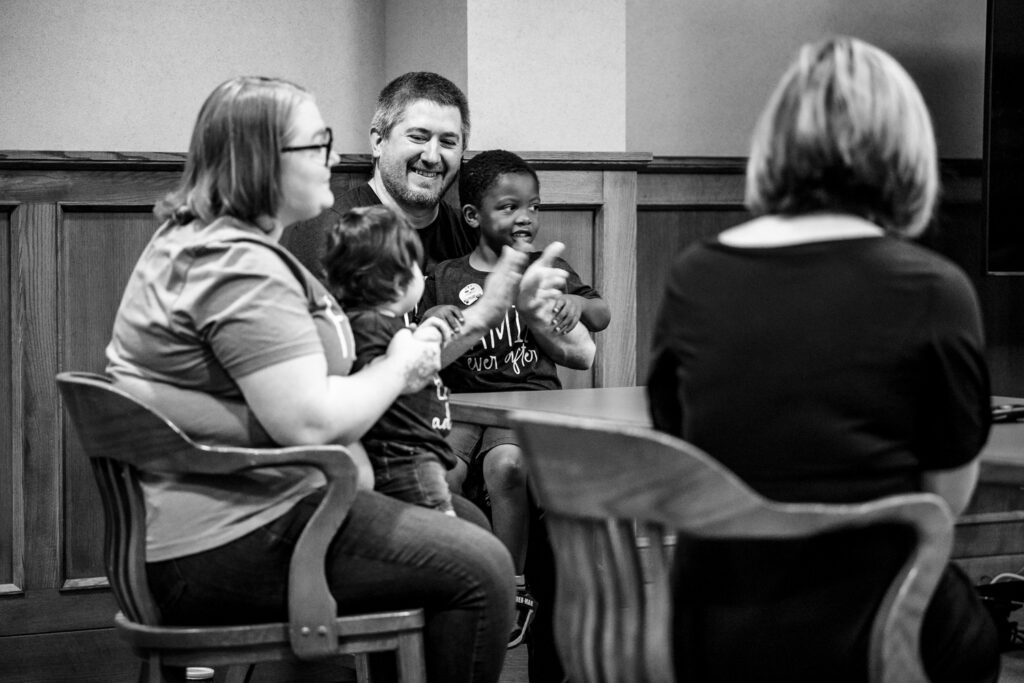 Family celebrates after they are granted official custody during adoption court hearing.