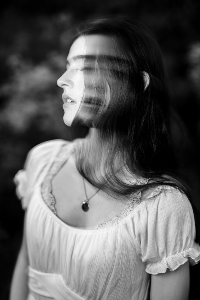 A long exposure of senior girl wearing white top.