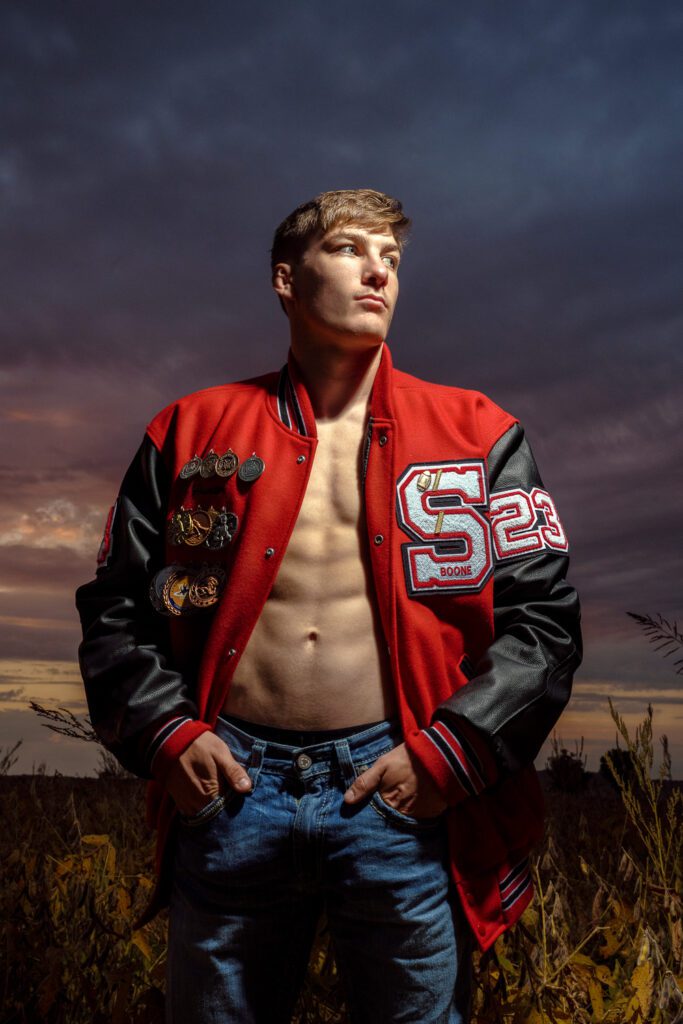 Southern Boone County Senior Wrestler poses shirtless with abs and letterman's jacket near Columbia, Missouri.
