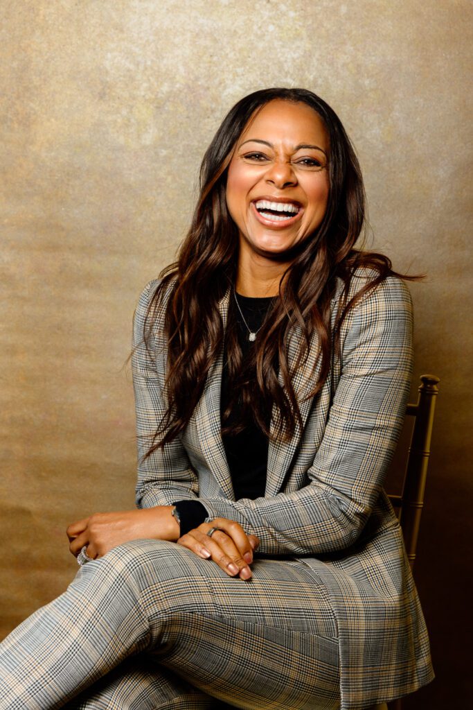 Entertainment Tonight Co-Host Nischelle Turner poses in front of Gold Canvas Backdrop at the University of Missouri.