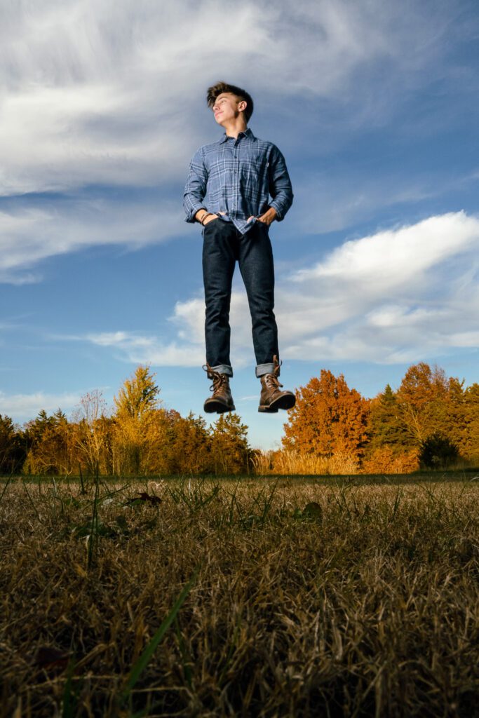 Senior guy jumps in air while making it look like he is just floating.