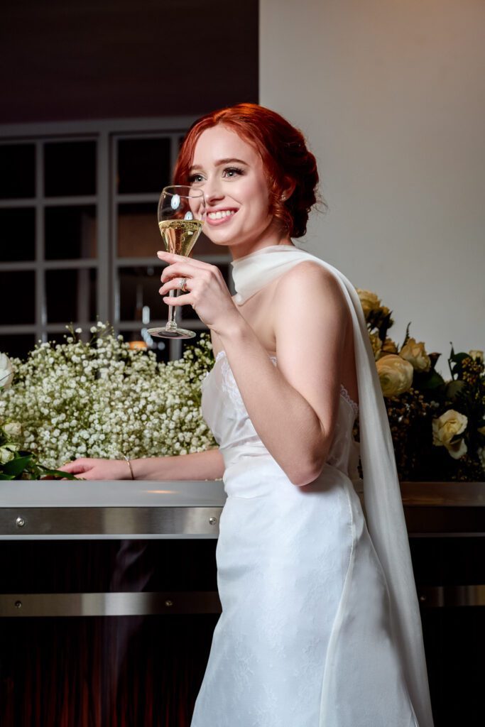 red head bride toasting with baby breath florals