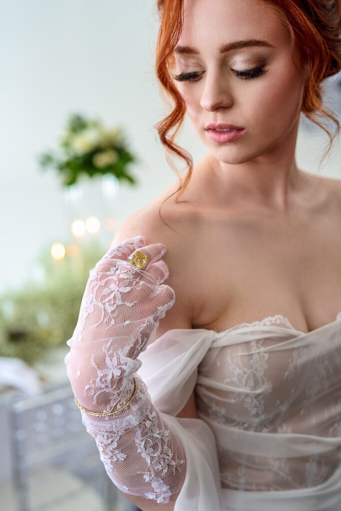 bride gazing down at wedding ring with red curls