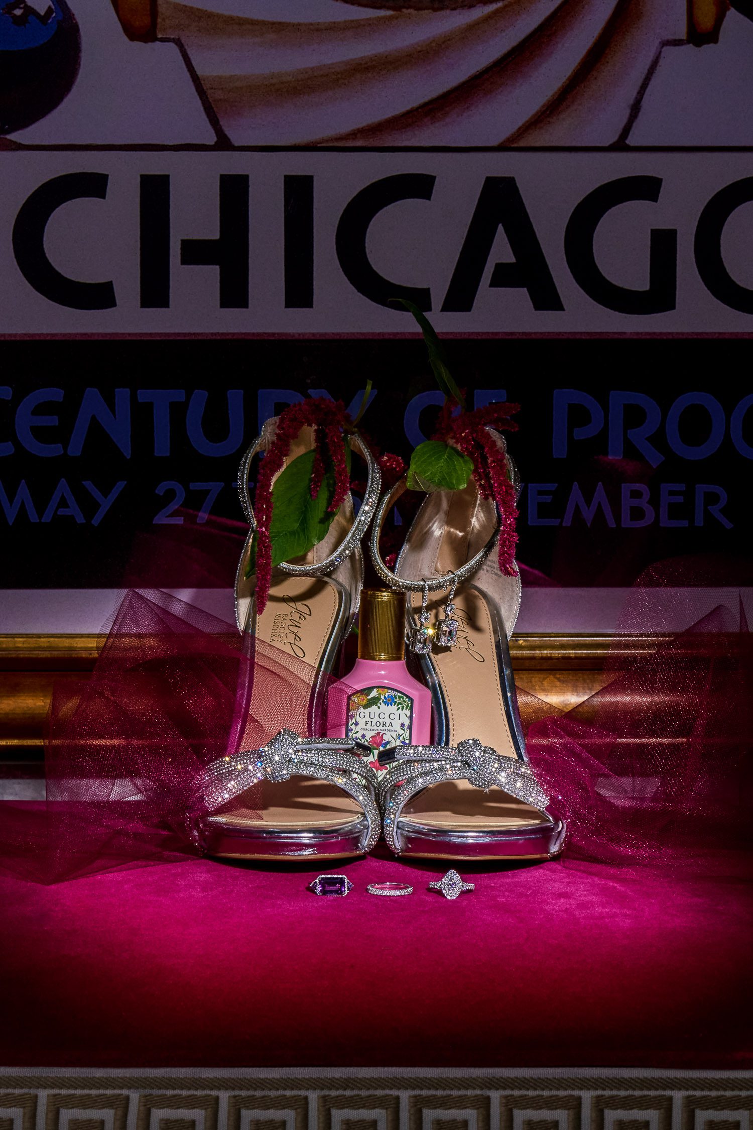 Jewelry and shoes on pink velvet bench for a flat lay type of image.