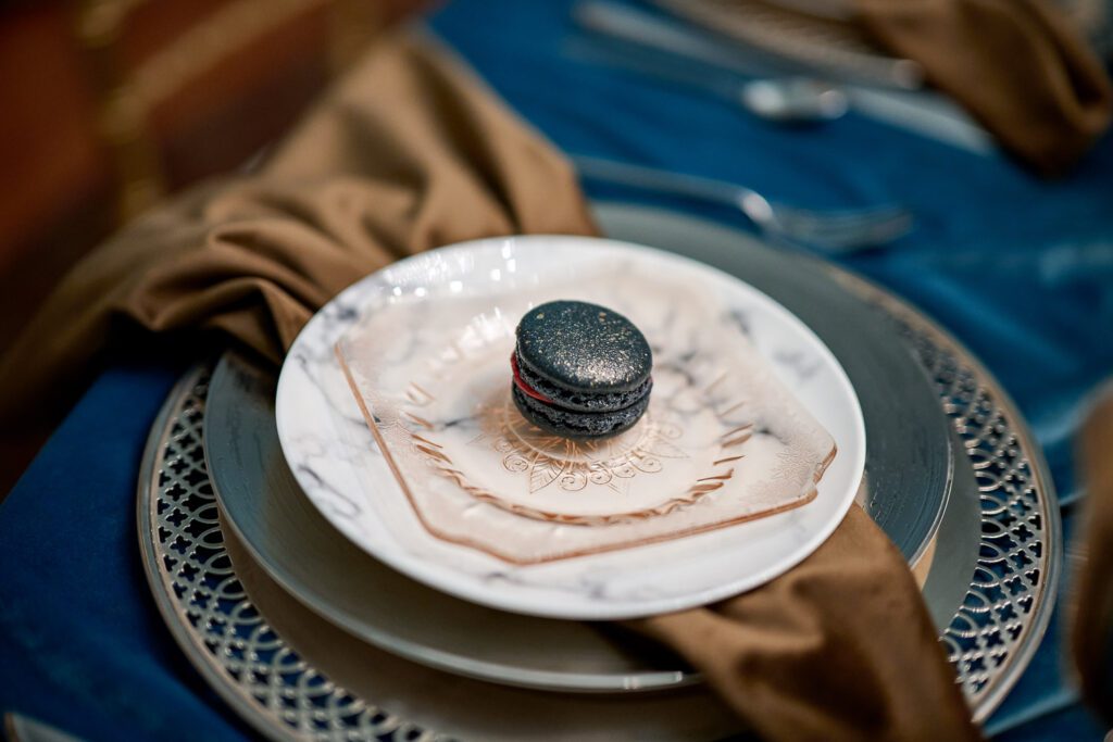 black glitter dusted macaroon on brown velvet napkin