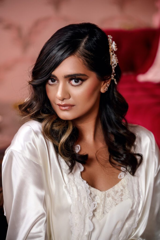 bride with hollywood waves and makeup in pink velvet room