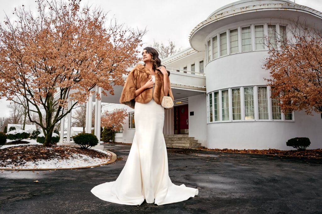 Indian Bride wearing vintage fur stands in front of Chatol Wedding and Events in Centralia Missouri.