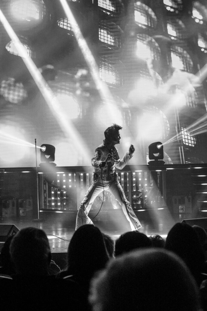 Dean Z dancing fiercely with hair flying on stage