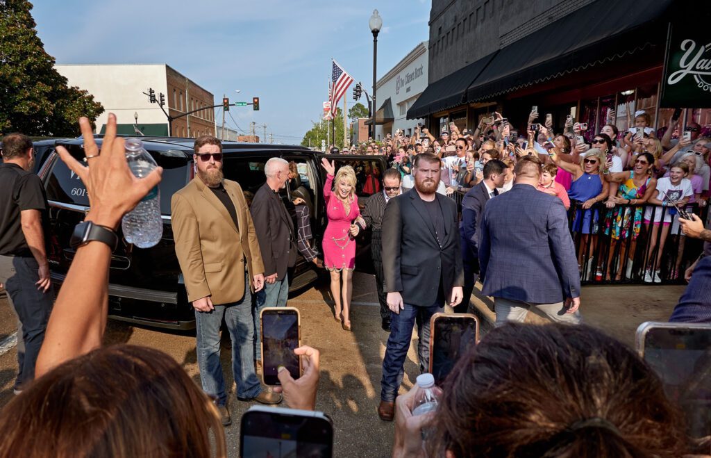 Dolly Parton with security guards