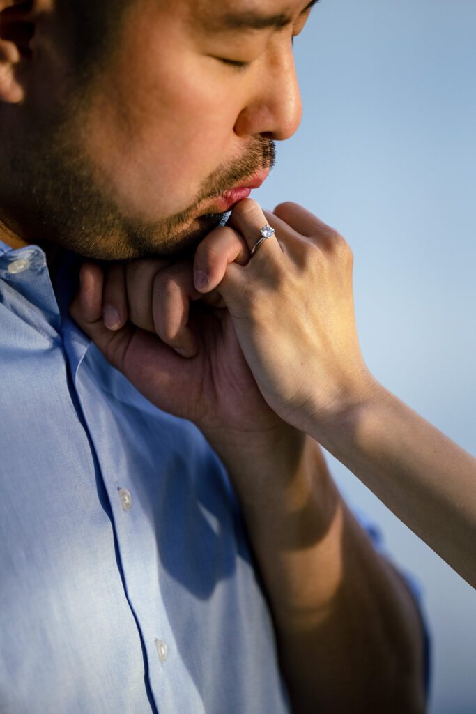 Guy kisses new fiances hand during engagement