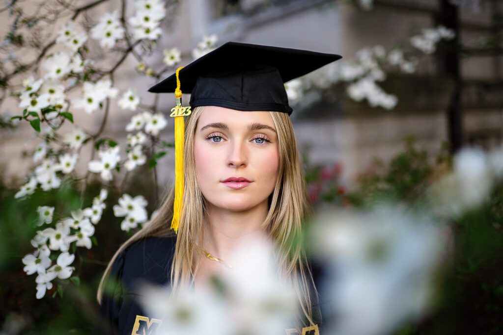 Mizzou senior woman wearing mortar board in white flowering dogwood tree