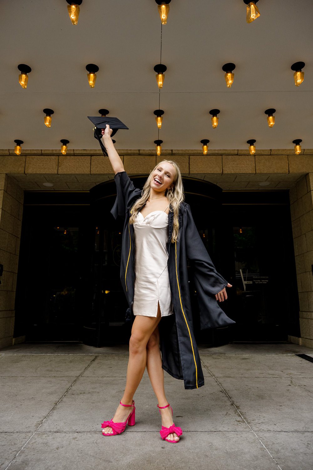 Blonde mizzou senior girl wearing cap and gown at tiger hotel