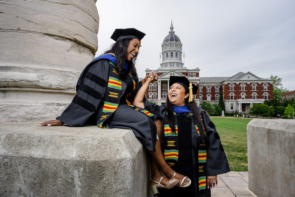 Two senior women laugh at mizzou columns jesse hall