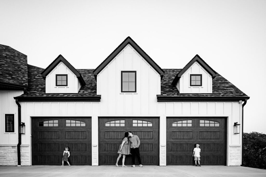 Family stand in front of their garage