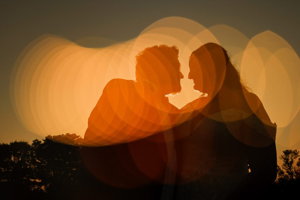 multiple exposure shot of bride and groom with orange bokeh lights