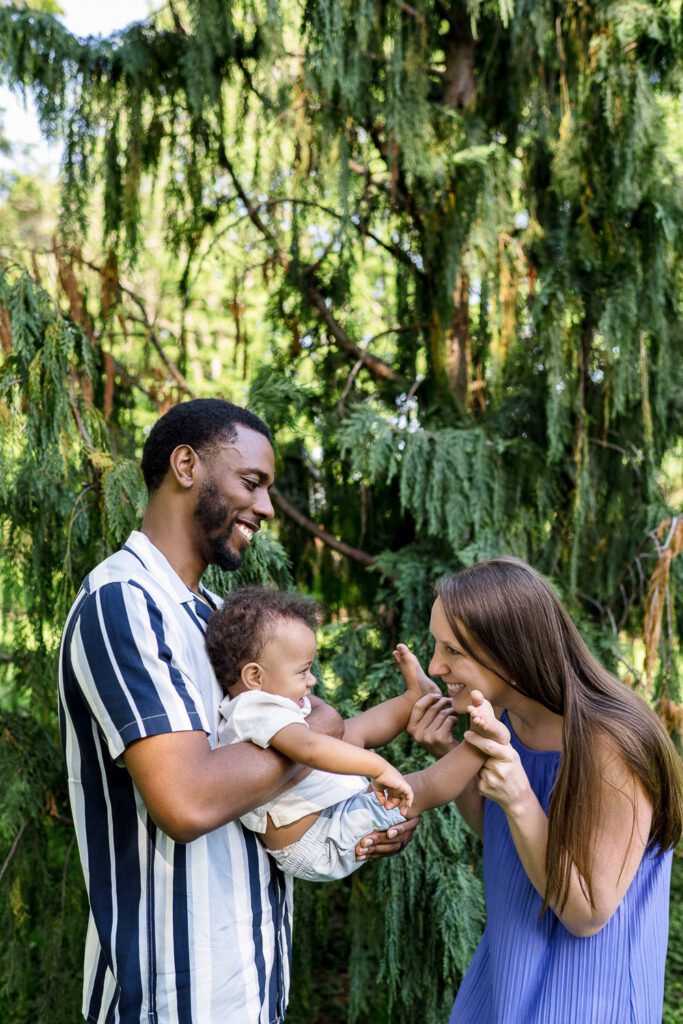 couple play with young child at shelter gardens