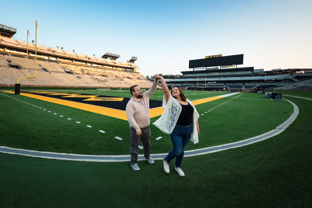 engaged couple dance on mizzou's faurot field