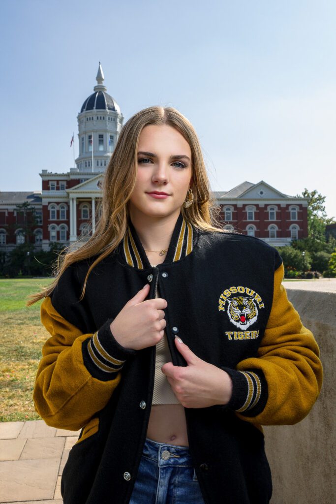 senior girl wearing dad's mizzou letter jacket