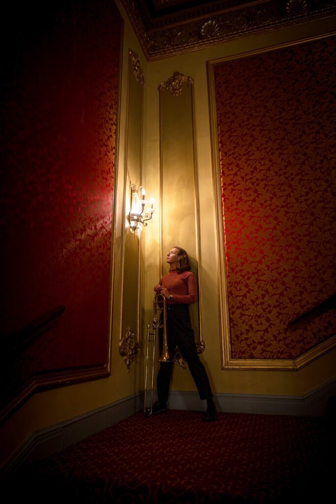 senior girl holds trombone at missouri theater