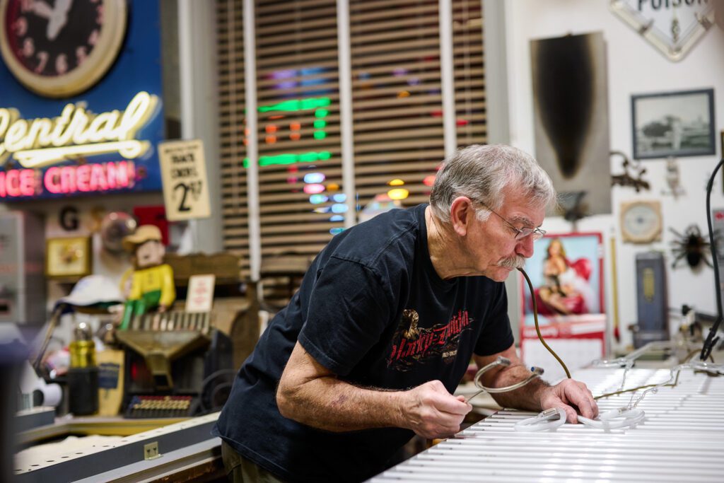Jim McCarter working on a neon sign for Schaefer Photography.