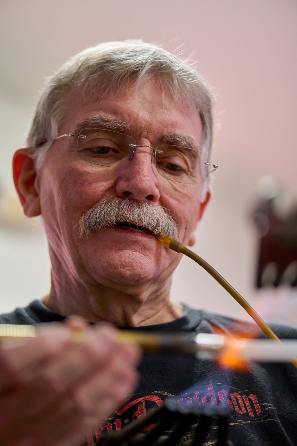 Jim McCarter melts electrode to glass neon tube