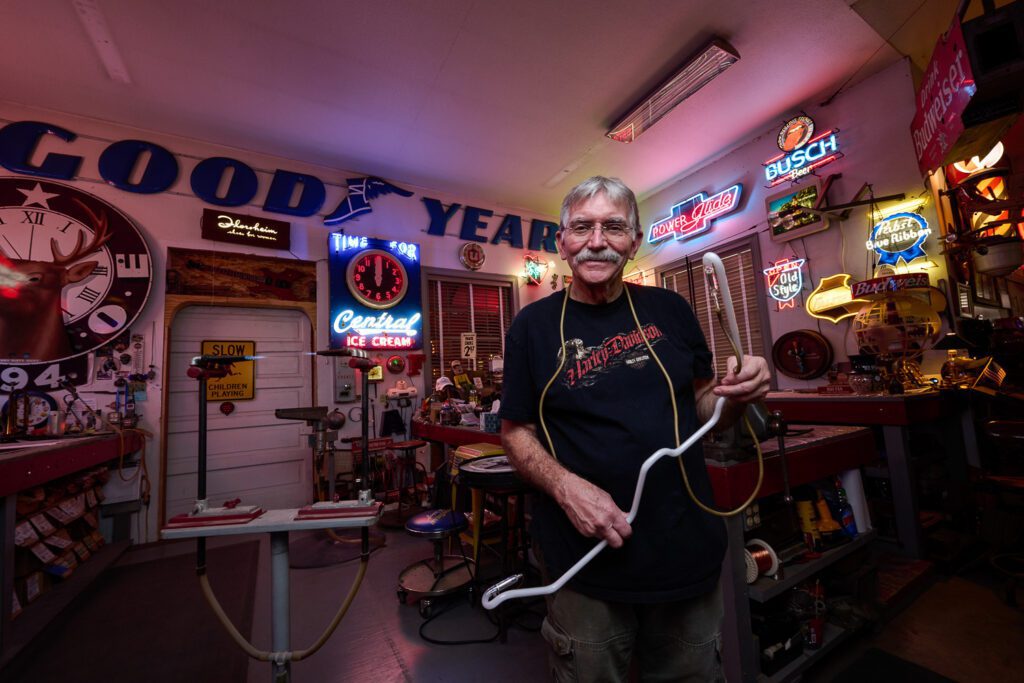 Jim McCarter of Creative Neon in Columbia MO poses for a portrait in his neon sign workshop.