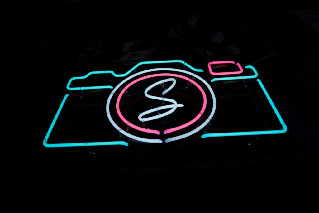 Schaefer Photography Neon Camera Sign with pink, turquoise and white neon tubes