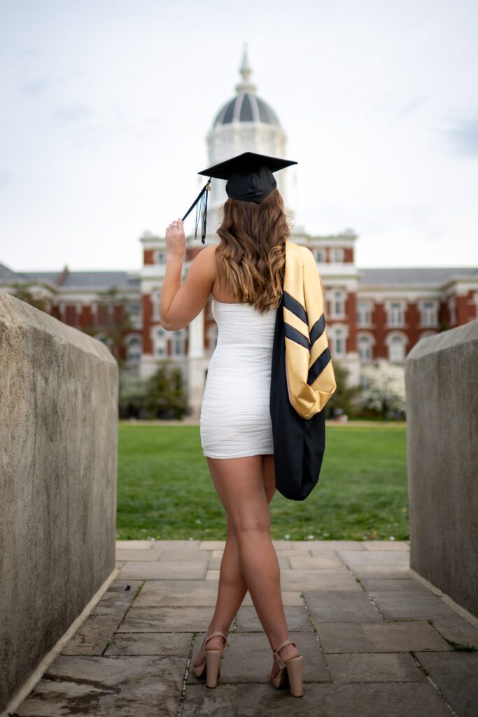 senior woman white dress looking at jesse hall