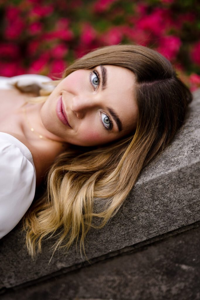 senior girl brunette hair red flowers