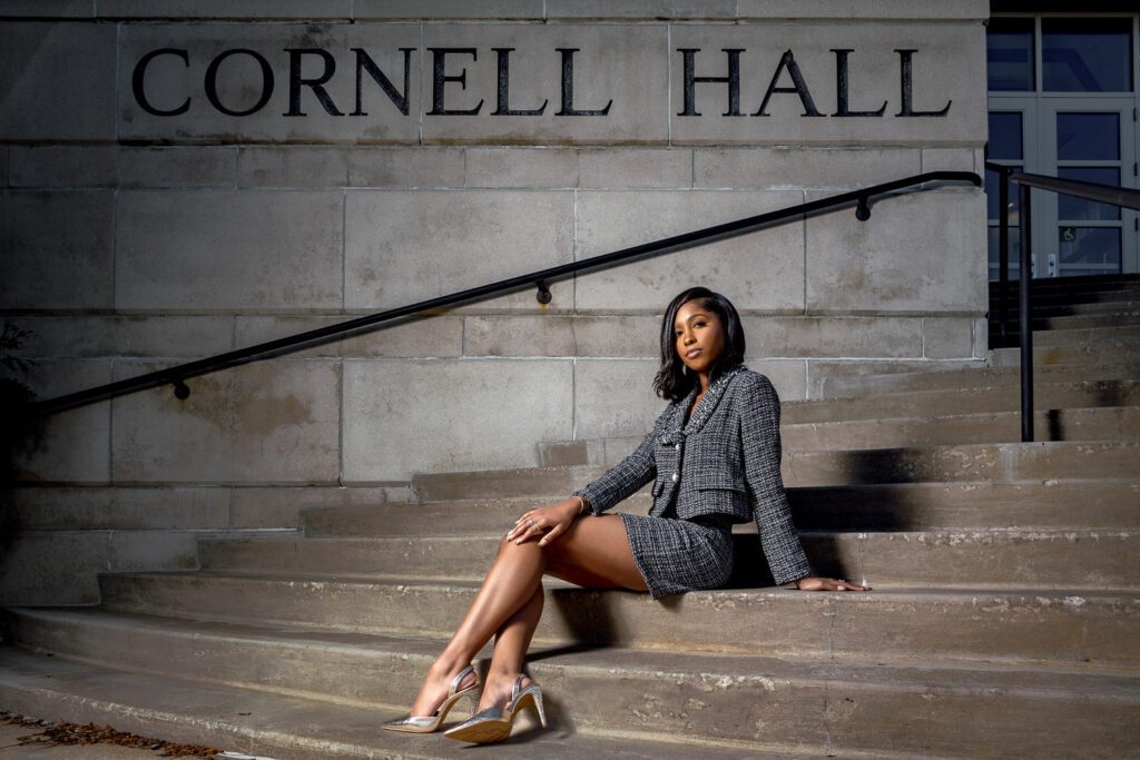 business woman sitting on steps of cornell hall mizzou senior woman