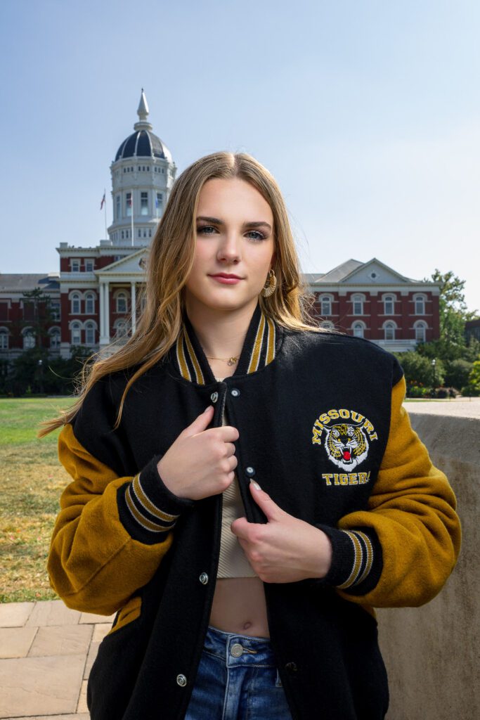 senior girl wearing vintage missouri tigers lettermans jacket