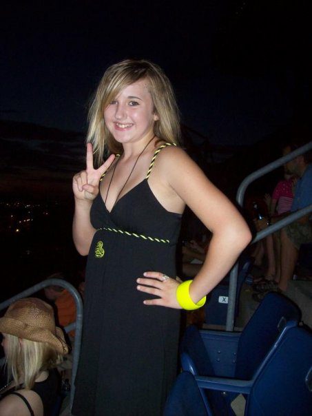 Young woman at Taylor Swift Concert at CMA Festival gives peace sign.