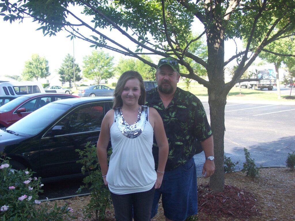 Johanna and her dad stand in front of car before taylor swift concert