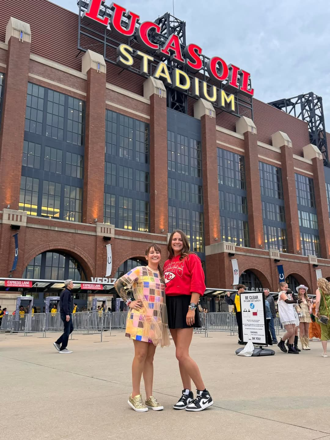 Two taylor swift fans stand in front of Lucas oil stadium