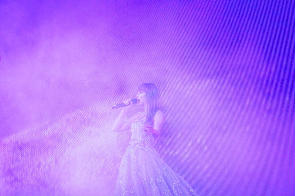 taylor swift performs in princess dress under purple light