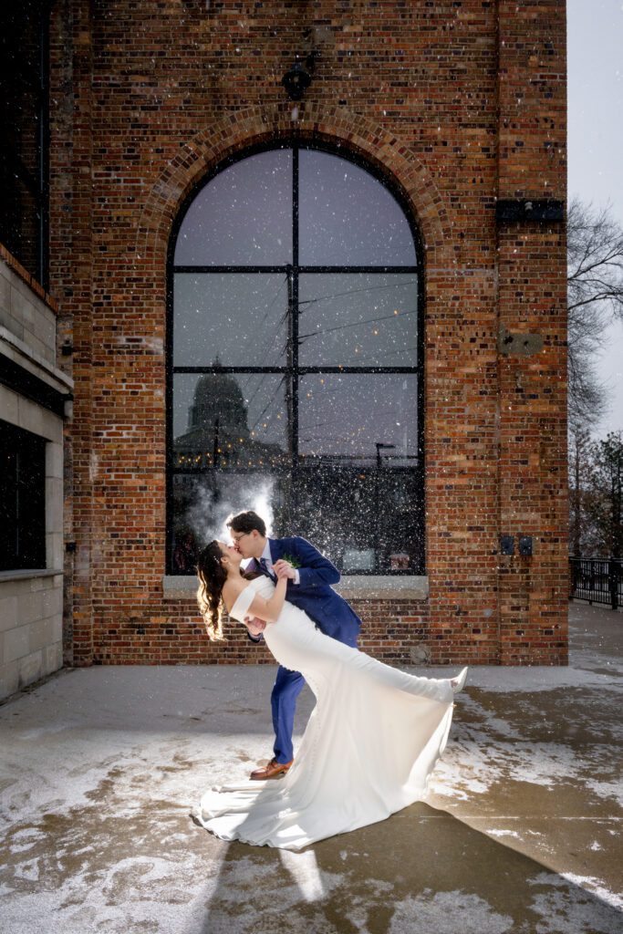 bride and groom kiss on cold winter day in jefferson city missouri millbottoms