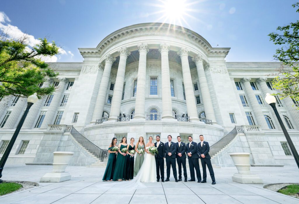 wedding party in front of jefferson city missouri state capitol building on sunny day