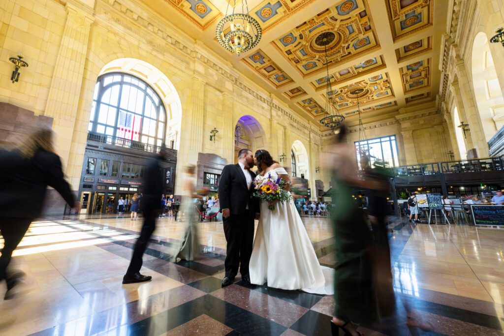 bride and groom kiss in union station kansas city