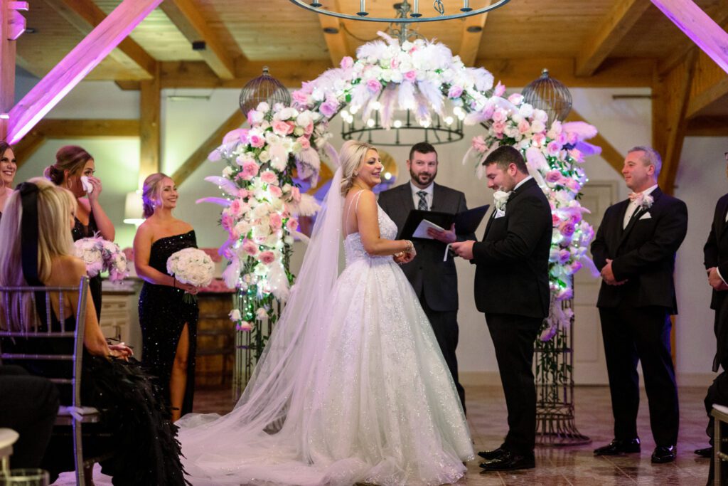 bride and groom exchange vows under flowers
