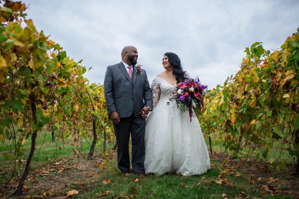 black groom and Hawaiian bride in grape vines vinyard